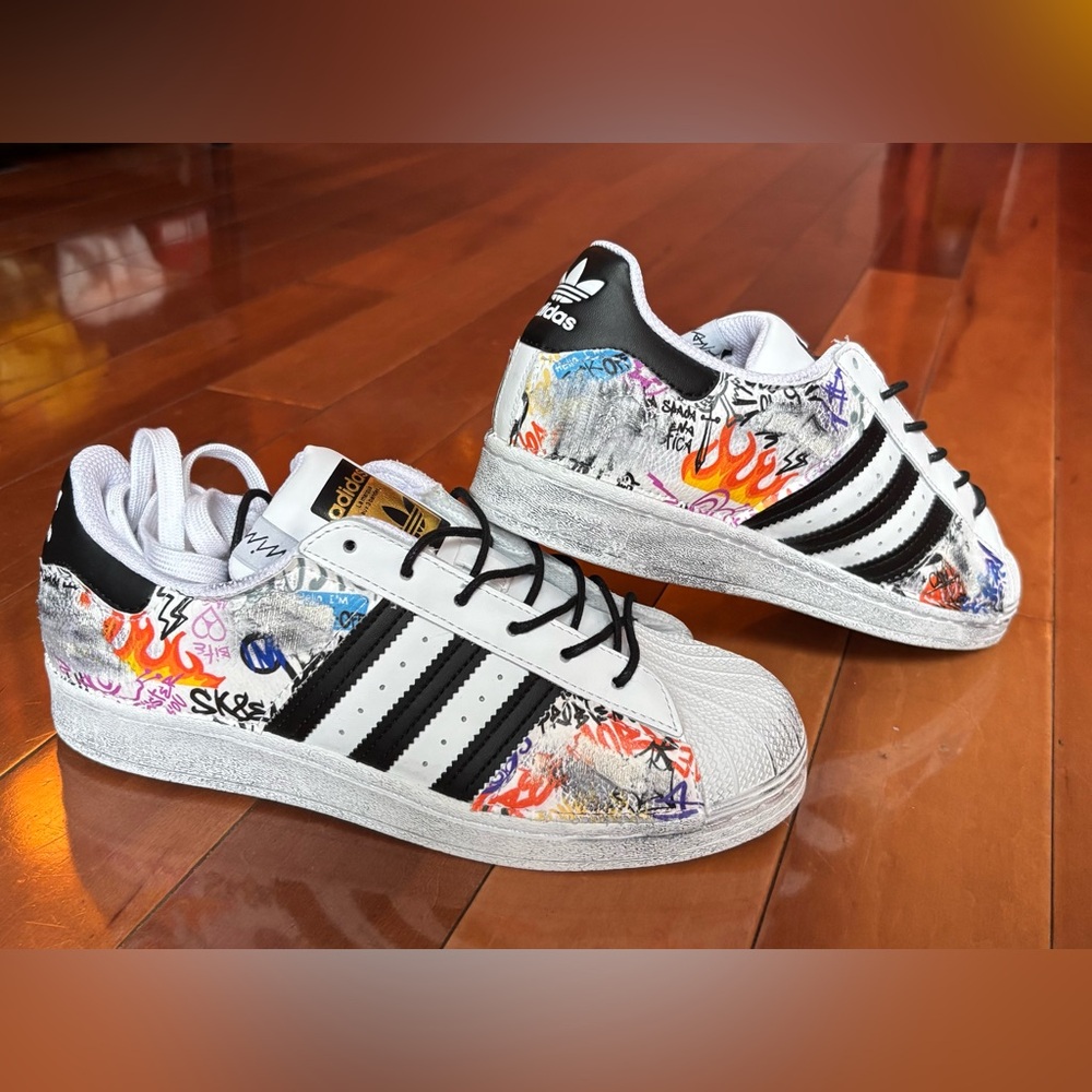 Adidas women’s sneakers size 8.5. White custom distressed graffiti. Nbw